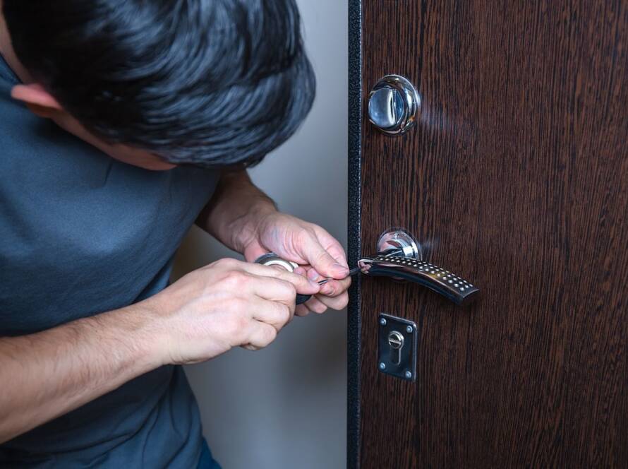 Locksmith replacing the door lock with a new one after losing keys