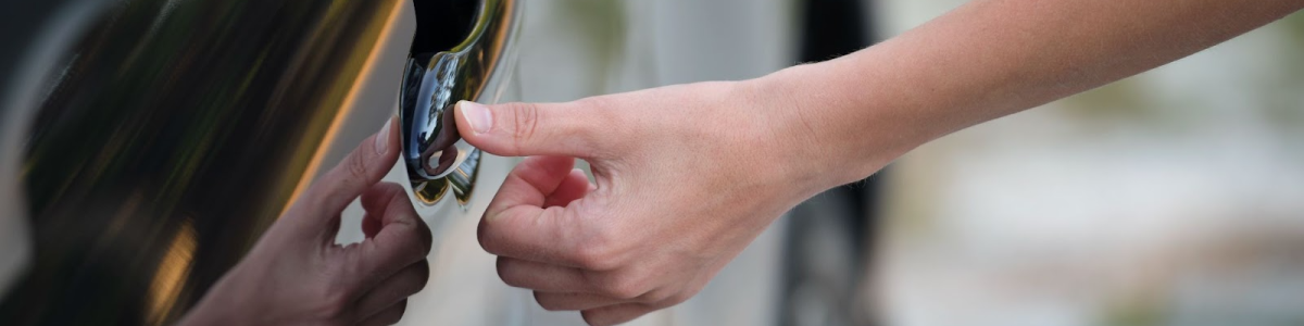 Driver unlocks a car door using a fingerprint touch sensor on the front handle