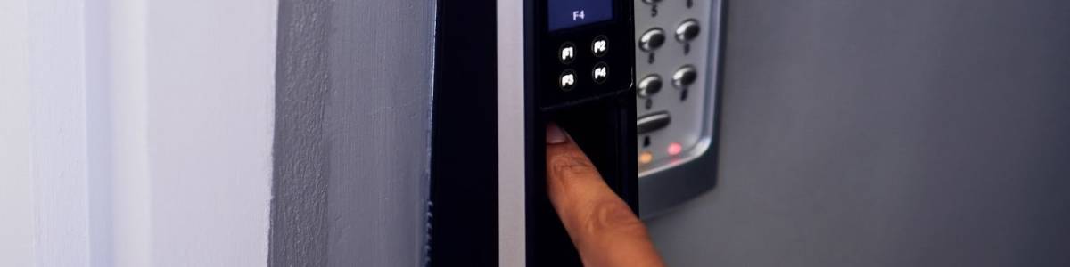 Commercial locksmith verifying a smart lock’s fingerprint access system